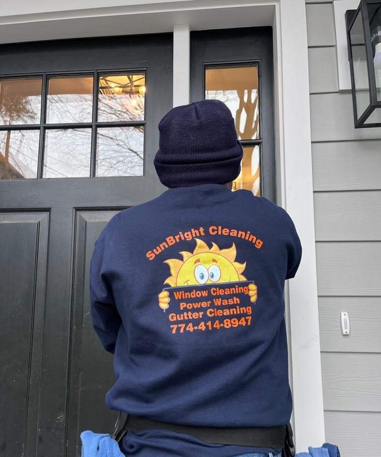 Sunbright Cleaning crew member in branded jacket at a job site